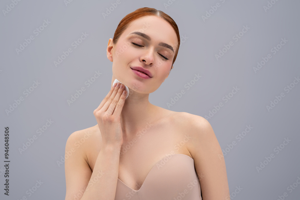 Cute young woman cleaning her face with a sponge Cute young woman cleaning her face with a sponge