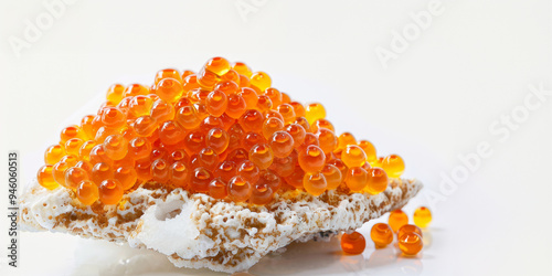 Red salmon caviar on sea stone with white background. photo