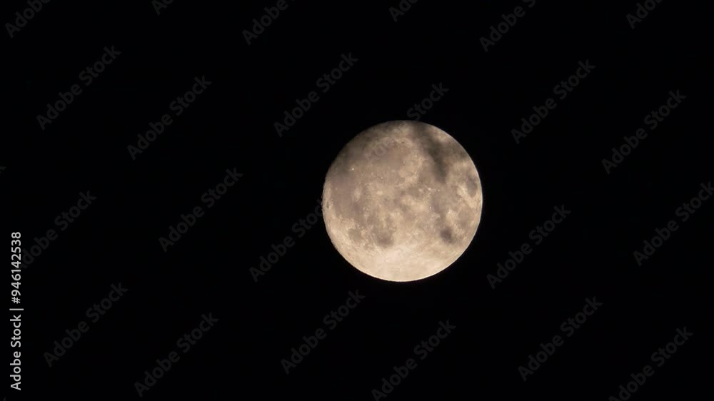 The full moon moving quickly and floating among the clouds in the midnight sky, The full moon moving quickly and floating among the clouds in the midnight sky,