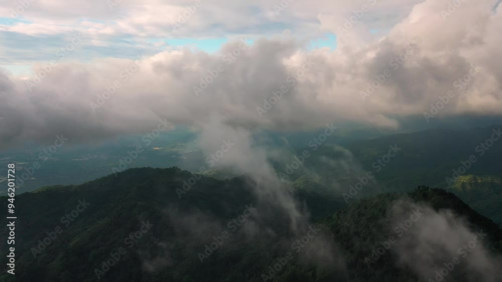 Aerial view of majestic mountains enveloped in fog and clouds, remote Fiji. Aerial view of majestic mountains enveloped in fog and clouds, remote Fiji.