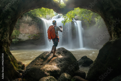 Fototapeta Naklejka Na Ścianę i Meble -  A man taking photo of the beauty of Haew Suwat Waterfall Khao Yai National Park Nakhon Ratchasima Province, Thailand.
