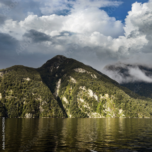 view to the cloudy mountains of the Doubtful Sound in Fiordland, south west of New Zealand photo