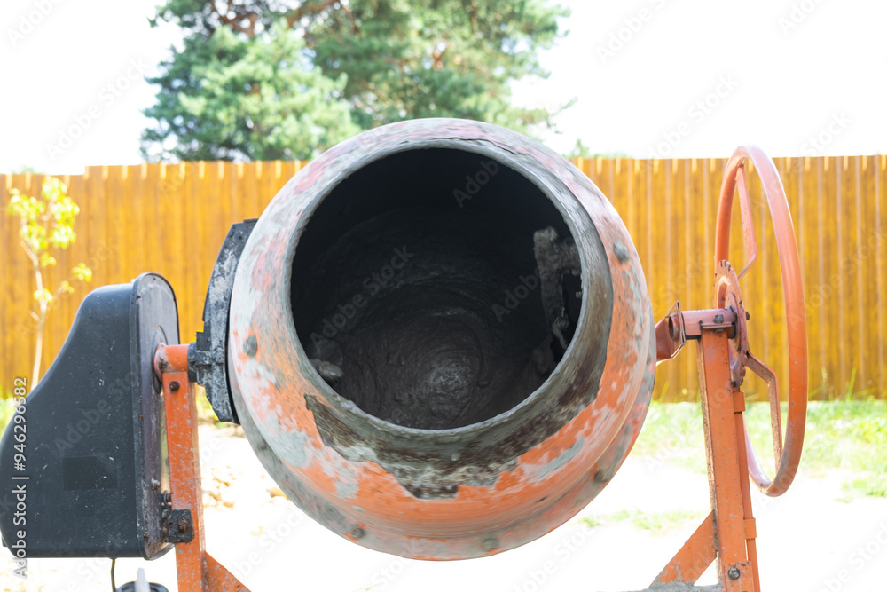 Mixing mortar in a handheld portable concrete mixer Mixing mortar in a handheld portable concrete mixer