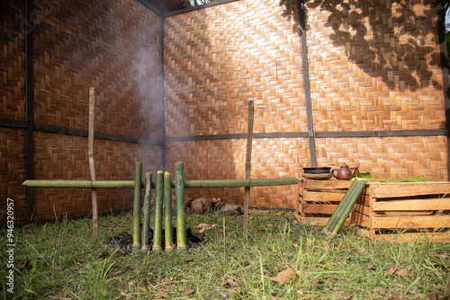 The process of making lemang, a food that is quite well-known in Malaysia and Indonesia. A man is making lemang, a food made from sticky rice that is put into bamboo lined with banana leaves