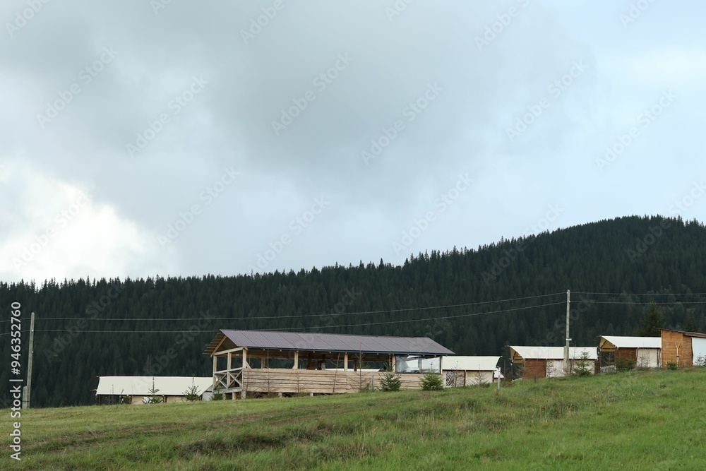 Many buildings in mountains at summer. Glamping site Many buildings in mountains at summer. Glamping site
