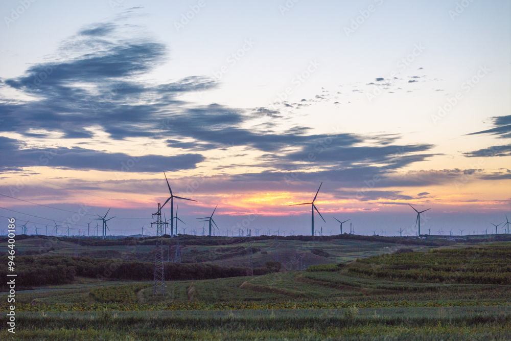 view of wind power turbine in field at sunset view of wind power turbine in field at sunset