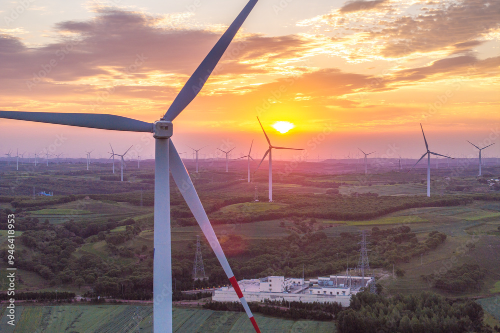 view of wind power turbine in field at sunset view of wind power turbine in field at sunset