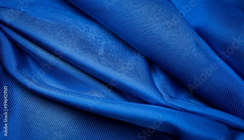 High-quality silk or satin fabric in a rich royal blue hue, showcasing a luxurious drape and smooth texture.