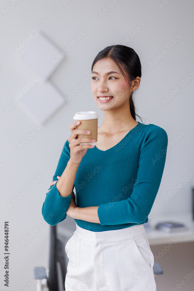 Young successful employee business asian woman in blue shirt work hold takeaway delivery craft paper cup coffee to go stand at desk with laptop pc computer at office. Young successful employee business asian woman in blue shirt work hold takeaway delivery craft paper cup coffee to go stand at desk with laptop pc computer at office.