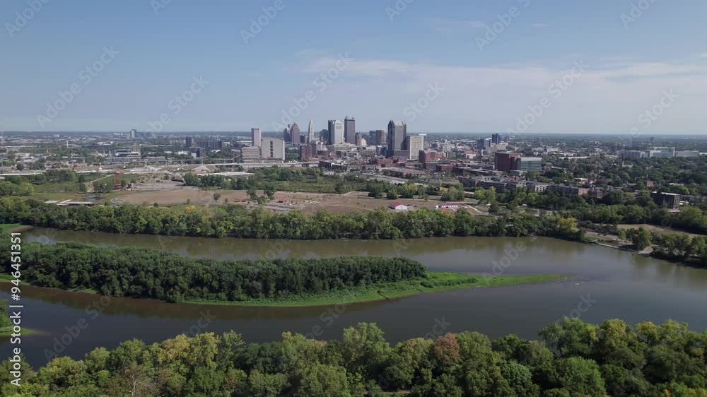 Population and capital city center of Columbus, OH, with aerial view of Scioto river, buildings, skyscrapers, business, traffic, metro parks, and Ohio people on a sunny summer day Population and capital city center of Columbus, OH, with aerial view of Scioto river, buildings, skyscrapers, business, traffic, metro parks, and Ohio people on a sunny summer day