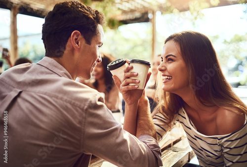 Happy, couple and linking arms with coffee at cafe for bonding, conversation and celebration together. Man, woman and warm drink with gesture at restaurant for gathering, romance and connection