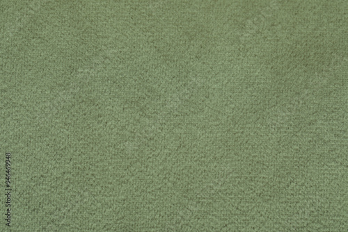 Sage color fabric as background, closeup view