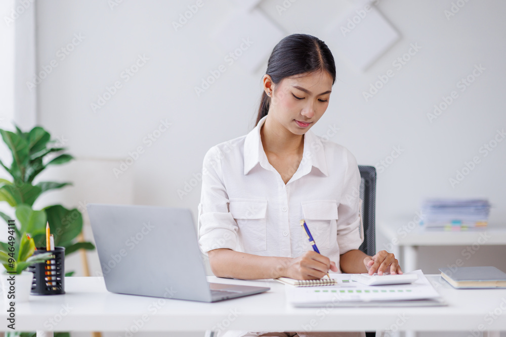 Asian Business woman using calculator and laptop for doing math finance on an office desk, tax, report, accounting, statistics, and analytical research concept
Asian Business woman using calculator and laptop for doing math finance on an office desk, tax, report, accounting, statistics, and analytical research concept