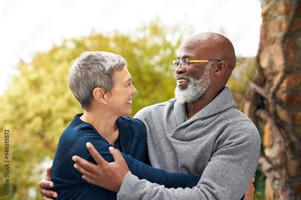 Fototapeta premium Interracial senior couple, smile and love in park, garden or nature for hug or care together. Happy man, woman and partner for retirement, relax and support for marriage and vacation for pensioner