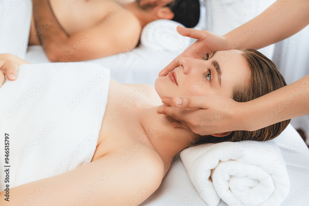 Caucasian couple enjoying relaxing anti-stress head massage and pampering facial beauty skin recreation leisure in dayspa modern light ambient at luxury resort or hotel spa salon. Quiescent Caucasian couple enjoying relaxing anti-stress head massage and pampering facial beauty skin recreation leisure in dayspa modern light ambient at luxury resort or hotel spa salon. Quiescent