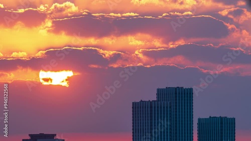 Timelapse of dramatic sunrise with orange sky in a sunny day.