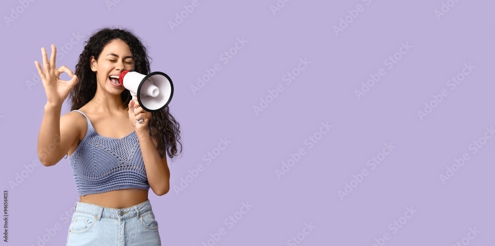 Obraz premium Young African-American woman with megaphone showing OK on lilac background with space for text