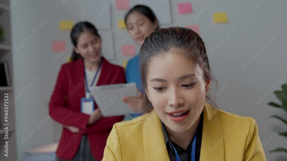 Three young businesswomen in an office celebrate a recent success while looking at a tablet. Their happiness and teamwork highlight a significant achievement in their corporate journey Three young businesswomen in an office celebrate a recent success while looking at a tablet. Their happiness and teamwork highlight a significant achievement in their corporate journey