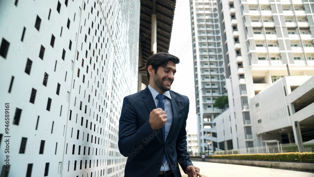Skilled business man dancing with joyful while walking in city street. Project manger receive a good news, getting promotion, getting a successful job while express feeling of overjoy. Exultant. Skilled business man dancing with joyful while walking in city street. Project manger receive a good news, getting promotion, getting a successful job while express feeling of overjoy. Exultant.