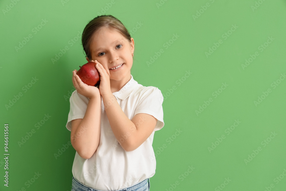 Little girl with apple on green background Little girl with apple on green background