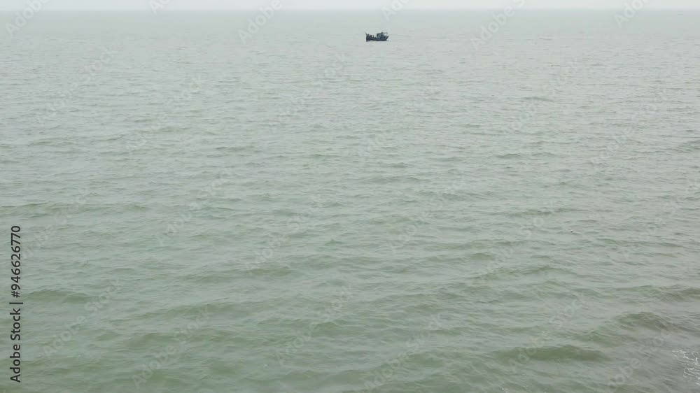 Aerial image of a lone fishing boat sailing in the calm sea waters, showcasing tranquil and serene seascape in Bangladesh. tilt up, push forward Aerial image of a lone fishing boat sailing in the calm sea waters, showcasing tranquil and serene seascape in Bangladesh. tilt up, push forward