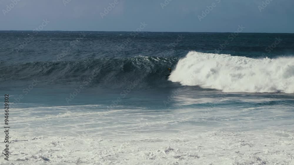 A surfer riding a wave in Jardim do Mar, Madeira island. A surfer riding a wave in Jardim do Mar, Madeira island.
