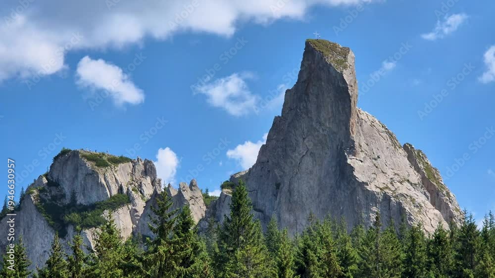 Timelapse of Pietrele Doamnei Mountain Peak and the Rarau Mountains, Surrounded by Fast-Moving White Clouds in the Bucovina Region, Romania Timelapse of Pietrele Doamnei Mountain Peak and the Rarau Mountains, Surrounded by Fast-Moving White Clouds in the Bucovina Region, Romania