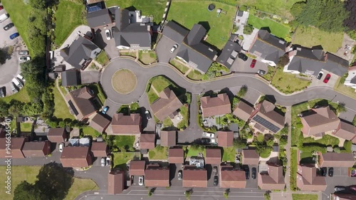 Top-down aerial pull-out of new build houses in a cul-de-sac layout, showcasing modern residential design with neatly landscaped yards in a suburban neighborhood