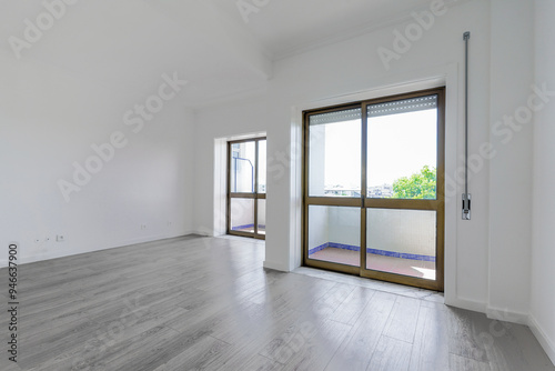 Empty new living room with two balconies facing the street with glass sliding doors photo