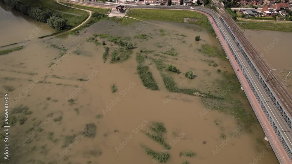 Forward aerial movement showing floodplains at river IJssel of tower town Zutphen urban development
