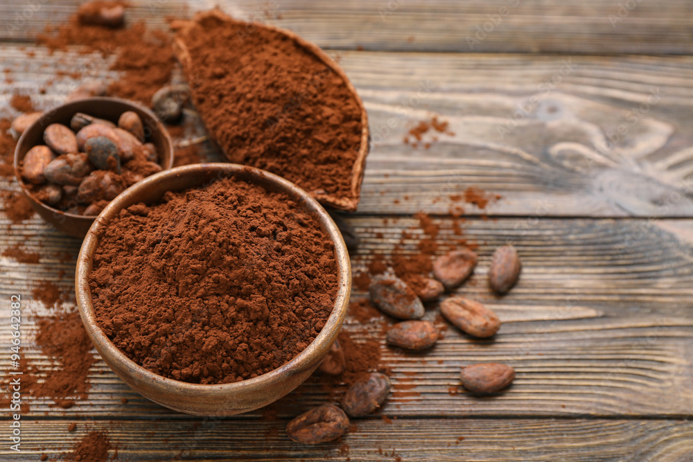Bowls with cocoa powder and beans on wooden background Bowls with cocoa powder and beans on wooden background