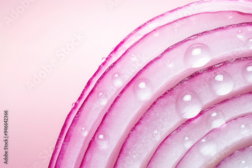 macro view of onion layers with dew drops on pink background