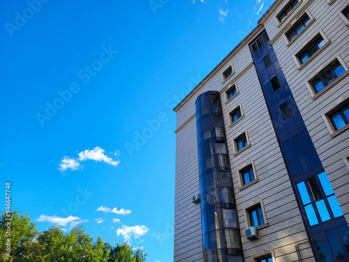 Beautiful facade of houses blue sky and white clouds on a bright sunny day