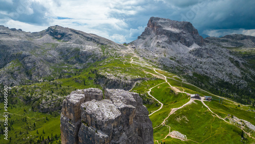 An aerial view of the incredible Cinque Torri mountains in the Dolomites, Italy, captured by a drone. This breathtaking shot showcases the dramatic rock formations and rugged beauty of  mountains photo