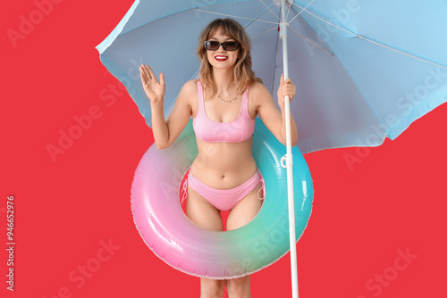 Young woman with beach umbr...