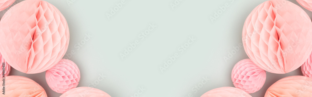 Obraz premium Banner with frame made of pink tissue paper balls on a blue background. Festive decorations.