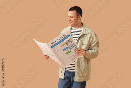 Smiling young man reading n...