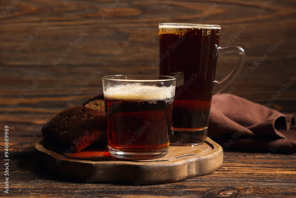 Glasses of fresh kvass and slices of bread on wooden background Glasses of fresh kvass and slices of bread on wooden background