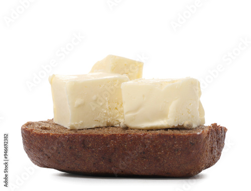 Bread with pieces of fresh butter on white background