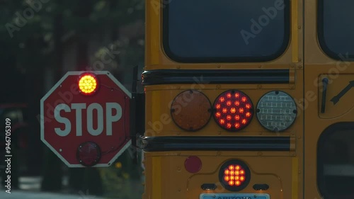 A school bus stop sign while picking up students at a bus stop