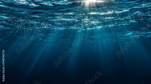 The background is made up of the sunbeams and the deep ocean or ocean under water.