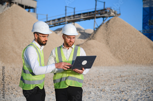 Two engineers at an industrial plant. Crushed stone production plant. Gravel photo