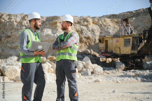 Workers talking in rock quarry