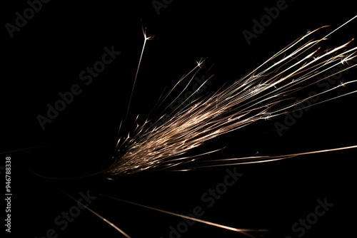 sparks from the grinder glowing in the dark
