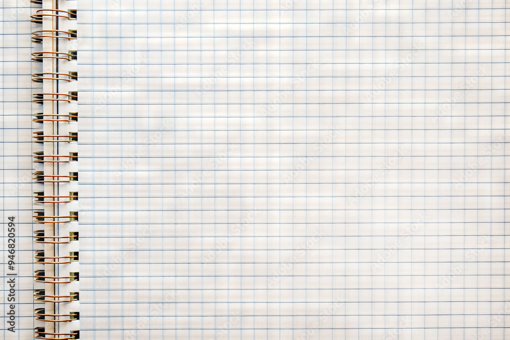 Close up of a spiral notebook with grid pattern pages Close up of a spiral notebook with grid pattern pages