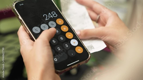 Wallpaper Mural A woman holds a paper receipt in her hand and counts her shopping expenses. close-up Torontodigital.ca