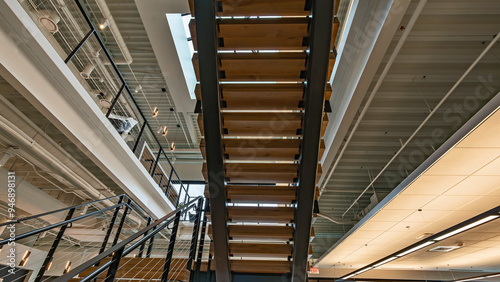 Wood and metal stairs viewed from below in a commercial building