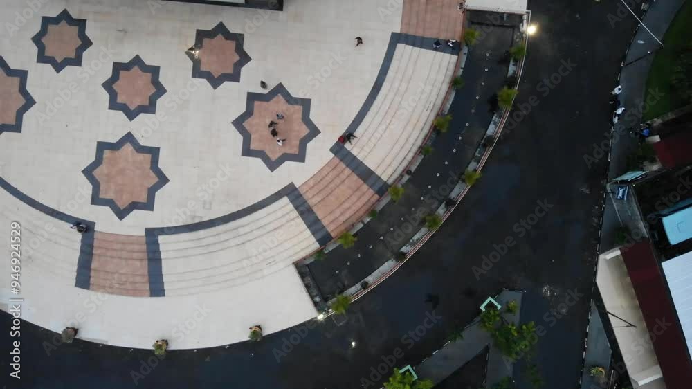 Aerial view of a courtyard with tiled steps and star patterns. Aerial view of a courtyard with tiled steps and star patterns.