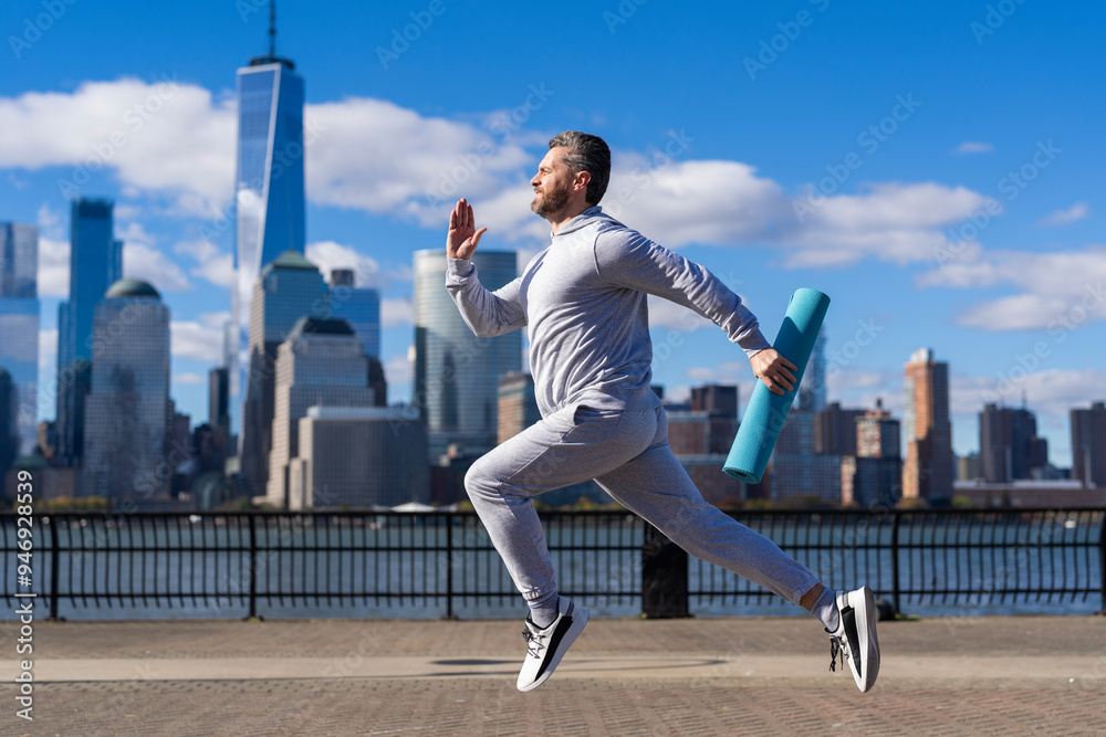 The sportsman running at view to New York. Man sportsman running for exercise in active wear. Sportsman jogger running. Sport runner in Manhattan. Run a marathon The sportsman running at view to New York. Man sportsman running for exercise in active wear. Sportsman jogger running. Sport runner in Manhattan. Run a marathon