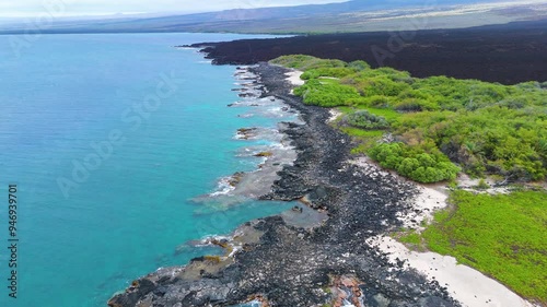 Aerial view of beautiful black sand beach with turquoise ocean waves and lush palm trees, Hawaii Island, United States. photo